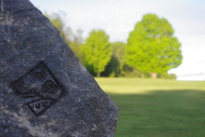 The Ridge logo on a rock