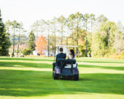 Wedding couple riding golf cart